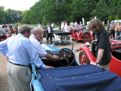 Brian Hogan discusses the finer points of owning a 4-seater LM with fellow 4-seater owner Eugene Abbondelo.  NASOC Pre-war Registrar and Editor can only watch and think how that lovely blue '35 LM 4-seater would look next to his '36 LM Speed Special!